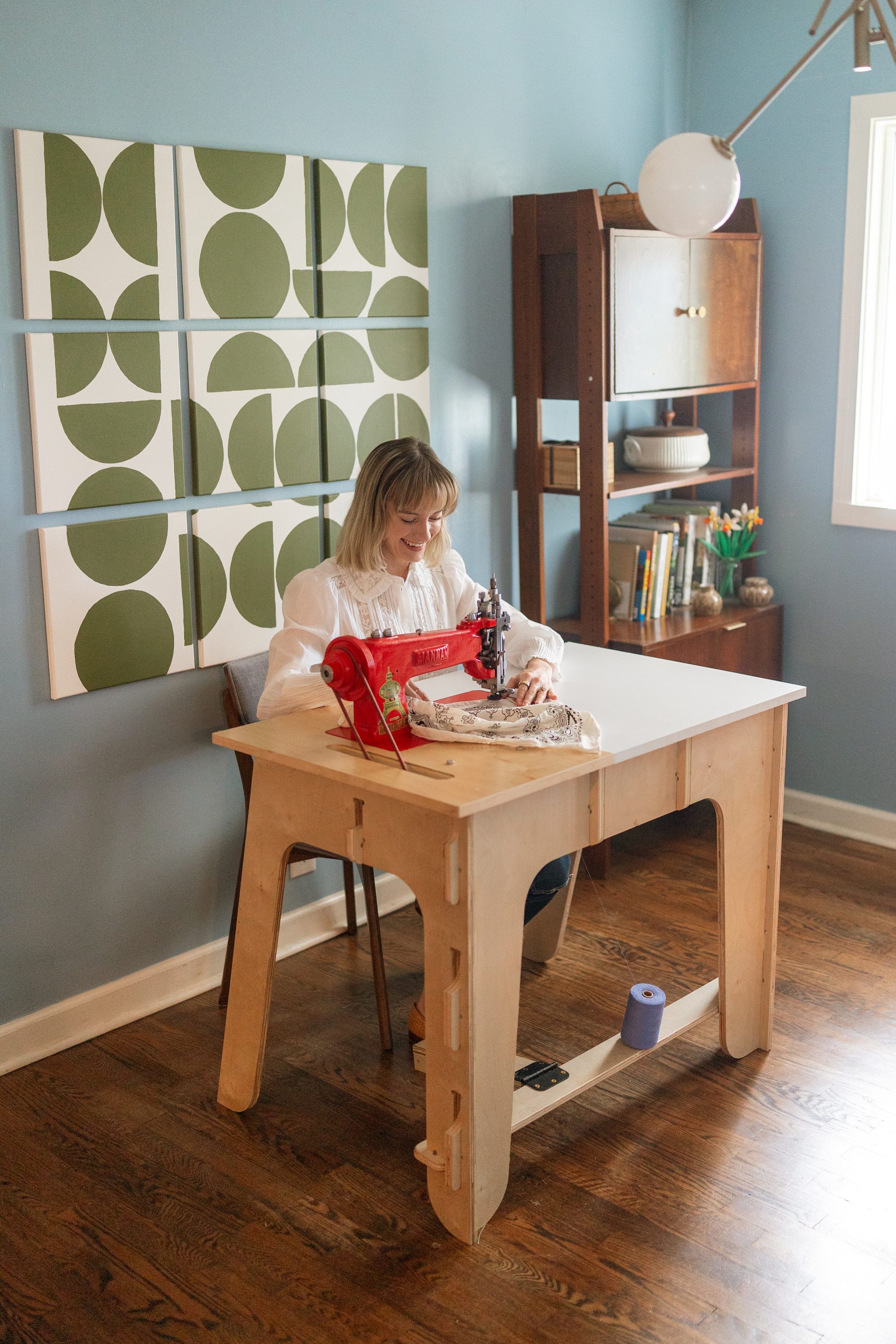 Chloe in her studio at the chainstitch machine