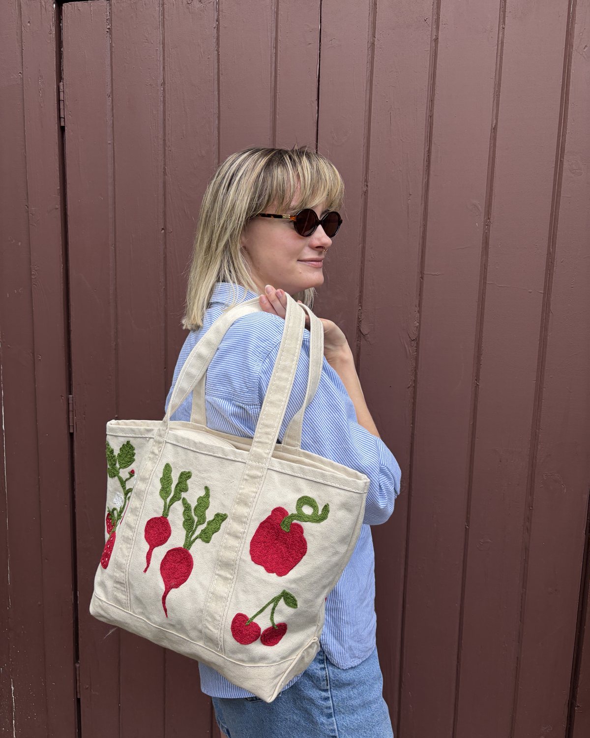 A finished chainstitch tote with radishes, a pepper, and cherries